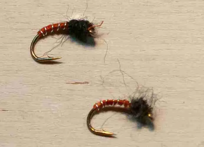 First, two zebra midges are tied with orange bodies