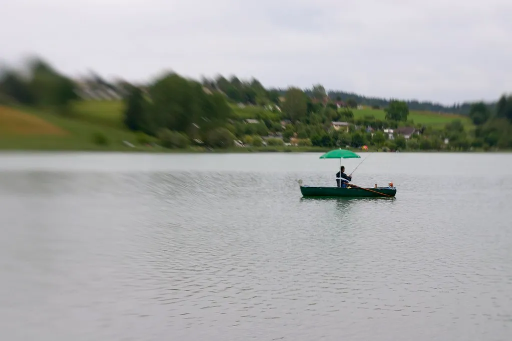 Fishing boat positioned strategically in choppy water with angler casting toward windblown shore
