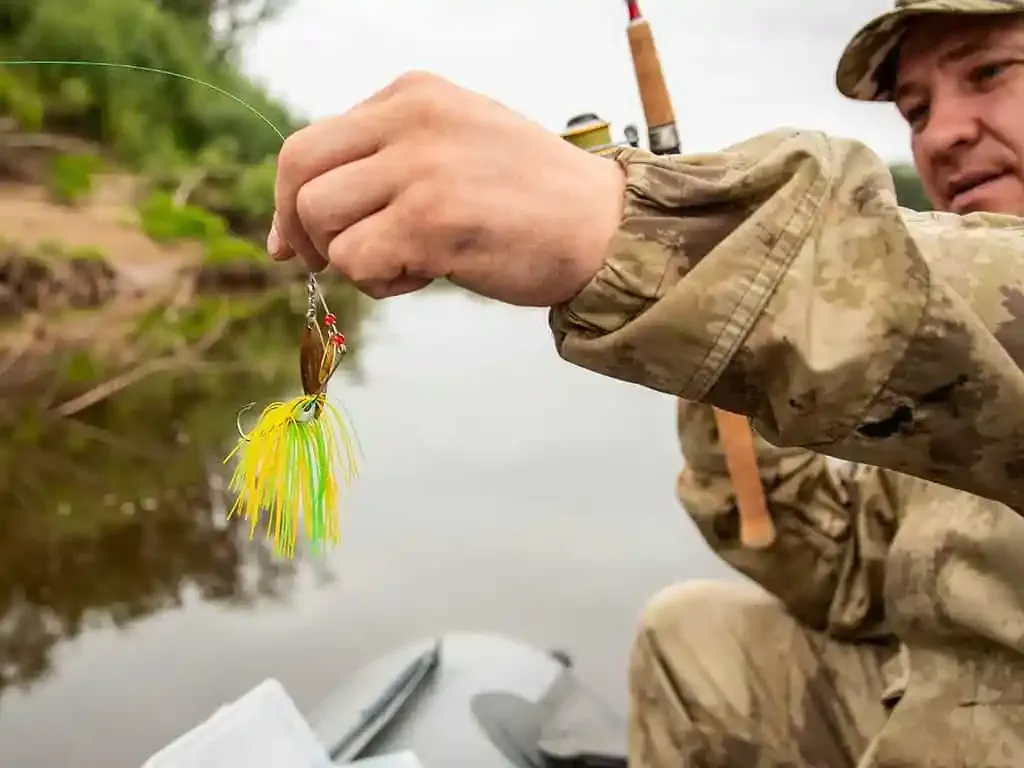 Angler demonstrating proper lure presentation in stream current with pike following