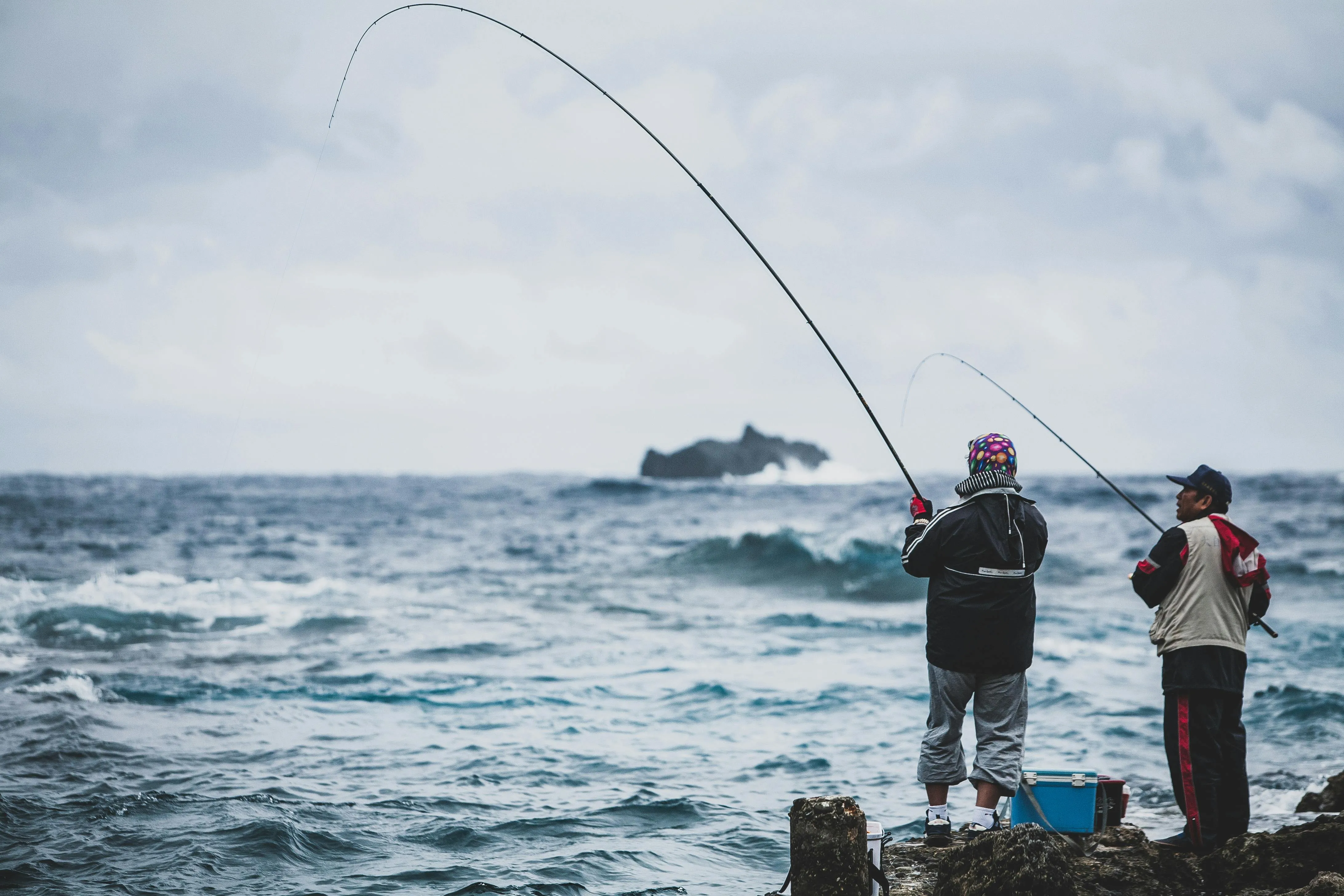 Angler fishing from shore in choppy, windy conditions
